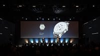 Product presentation on stage featuring a luxury watch displayed on a large screen during Watches & Wonders – Geneva International Watchmaking Exhibition.