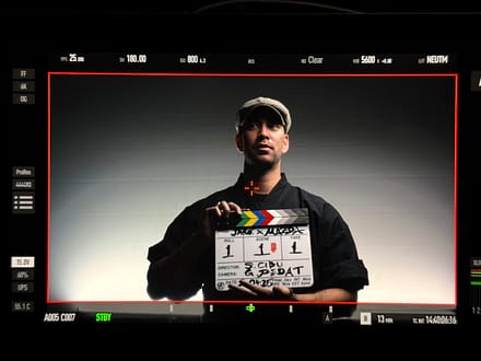 Artist holding a film clapperboard framed through a camera monitor during the Mazda – Cinematic reveal of the Mazda 6E.