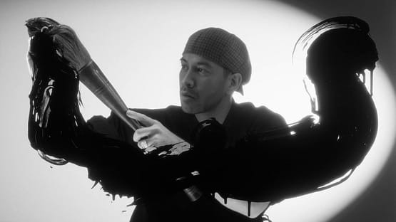 Artist performing a cinematic brushstroke gesture in black ink during the Mazda – Cinematic reveal of the Mazda 6E.